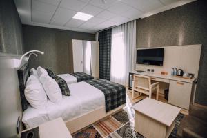 Postel nebo postele na pokoji v ubytování Badam d'Art Boutique Hotel