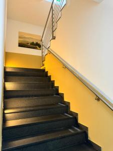 a staircase in a building with a painting on the wall at Stadtpension Heilbronn in Heilbronn