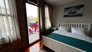 a bedroom with a bed and a large window at Lia Suit Beşiktaş in Istanbul