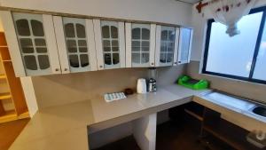 a kitchen with a white counter and a sink at Alma de cedrela in Puerto Ayora +177 photos