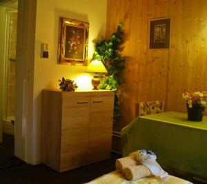 a room with a table and a dresser with a lamp at Apartment Herlikovice in Trutnov