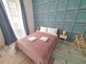 a bedroom with a bed with two towels on it at WE STAY APARTMENTS in Bratislava