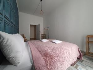 a bedroom with a bed with a pink blanket at WE STAY APARTMENTS in Bratislava