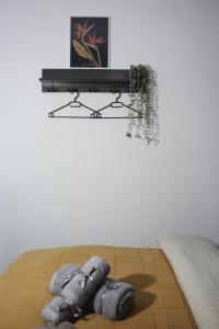 a teddy bear laying on a bed under a shelf at Center Of Elegance in Xanthi