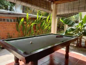 a pool table sitting on top of a patio at O'hamok family in Battambang