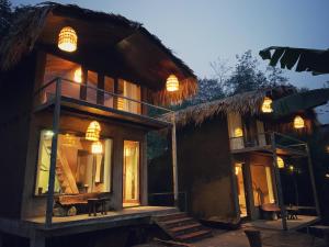 a house with a thatched roof with a porch at Sa Moc & La Maison SAPA - Bungalows in Sa Pa +106 photos