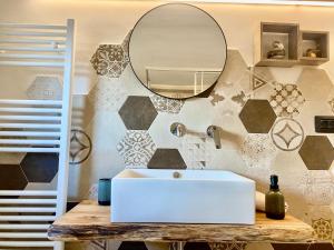 a bathroom with a white sink and a mirror at Ca' di Zio Tinu in Dronero +25 photos