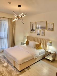 a bedroom with a large bed and a ceiling fan at White Sage - Tranquil Haven 1BR With Burj Views in Dubai