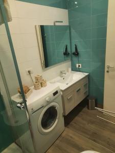 a bathroom with a washing machine and a sink at RiDi Home Zona Ospedaliera in Naples +25 photos