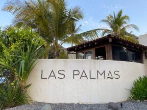 a sign that says las palms in front of a building at Villa Caracol in Las Palmas Luxury Villas in Barra de Potosi