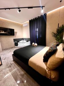 a bedroom with a large bed in a room at Falco Boutique Home with Jacuzzi in Naples