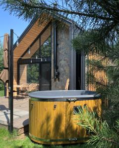 a hot tub in the backyard of a house at Mała Holenderka - Lewy Brzeg Narwi in Burlaki +8 photos