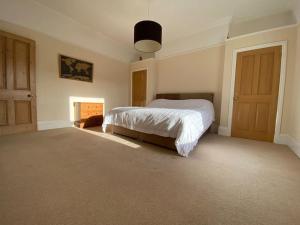 a bedroom with a bed and a fireplace at Dog friendly home close to the beach and the town in Exmouth