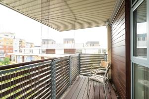 a chair sitting on a balcony with a window at Spacious Penthouse - Sleeps 6, Ideal for Contractors, Families & Business Travellers - Free Parking in Watford