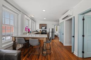 a kitchen with a large island in the middle of a room at Stylish Loft Steps Away from Main Street in Conway