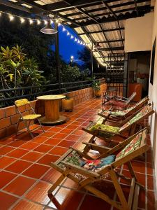 a patio with chairs and a table and lights at B&B Villa CALASAN in Garzón