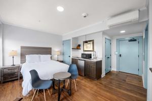 a hotel room with a bed and a table and chairs at Historic Elegance Loft in Downtown Conway in Conway