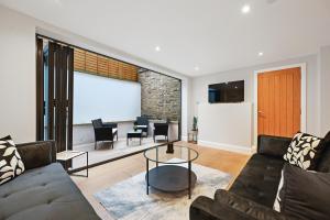 a living room with a couch and a table at Stunning 2 Bed basement flat in Hammersmith in London