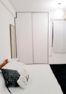 1 dormitorio con 1 cama con almohada blanca y negra en Hermoso Apart Barrio Sur en San Miguel de Tucumán