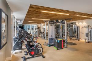 a gym with a bunch of treadmills and machines at Harbour Hotel & Spa Southampton in Southampton
