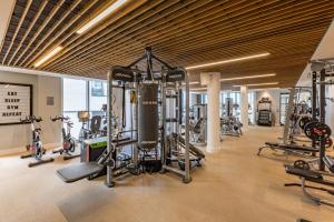 a gym with several treadmills and exercise bikes at Harbour Hotel & Spa Southampton in Southampton