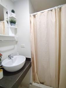 baño con lavabo y cortina de ducha en Bello departamento en altozano, en Tacna