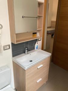 a bathroom with a sink and a mirror at 4STANZE in Naples +62 photos