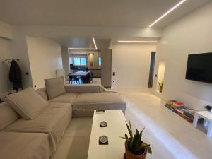 a living room with a couch and a table at Sapfo Luxury Apartment in Athens in Athens