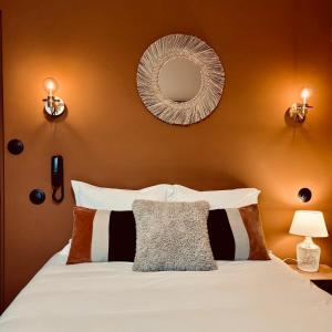 a bedroom with a bed with a mirror on the wall at Hôtel Rive Sud in Chinon