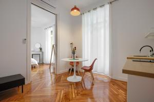 a kitchen with a table and a chair in a room at MEZZANINE ORANGE in Madrid
