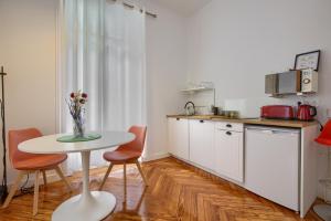 a kitchen with a table and chairs and a table at MEZZANINE ORANGE in Madrid