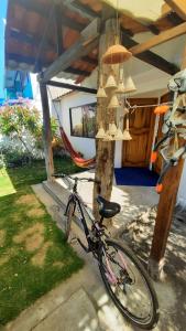 a bike parked in front of a house with chandeliers at Alma de cedrela in Puerto Ayora