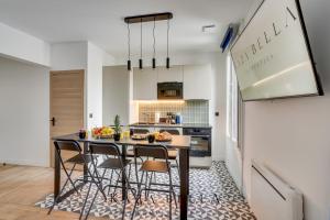 a kitchen with a table and chairs in a room at KAZA BELLA - Maisons Alfort 7 - Large modern family flat in Maisons-Alfort