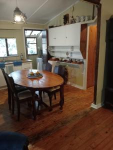 a kitchen and dining room with a table and chairs at Nature's Valley Health Retreat A Hide away in the Forest in Natureʼs Valley