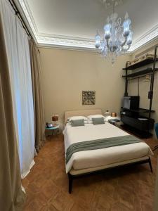 a bedroom with a bed and a chandelier at Domus Camillus in Milan