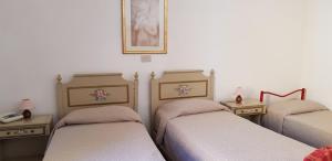 Letto o letti in una camera di Albergo Natucci