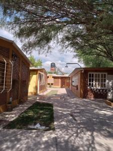 an empty courtyard of a building with a tree overhead at Brisas de montaña in Las Compuertas