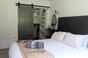 a bedroom with a large white bed and a closet at Cloud 9 : Where you can daydream in Kenton on Sea