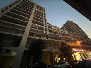 a tall building with cars parked in front of it at B&B Seataly Experience in Civitavecchia