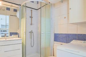 a bathroom with a shower and a toilet and a sink at Appartement vue mer 50m de la plage in Saint-Hilaire-de-Riez +17 photos