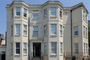 an apartment building with the words the love at B2, The Kové, West Hill Road in Bournemouth