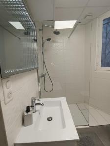 baño blanco con ducha y lavamanos en Foras Urban Living à 2 pas du festival, en Cannes