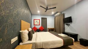 a bedroom with a bed and a flat screen tv at PHP BOUTIQUE TOWNHOUSE in Chennai