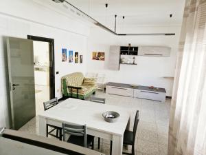 a kitchen and living room with a table and chairs at Vincenti's House Comiso in Comiso