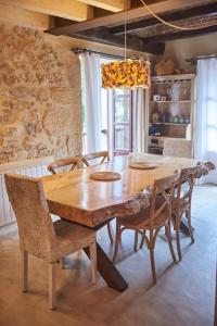 una mesa de madera y sillas en un comedor en Alojamiento y Visita a Bodega Miradorio Incluida, en Casasola