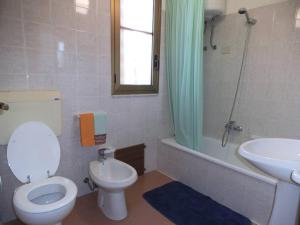 a bathroom with a toilet and a sink and a shower at Valle Verde 3 Clima & Wi-Fi in Castellammare del Golfo +4 photos