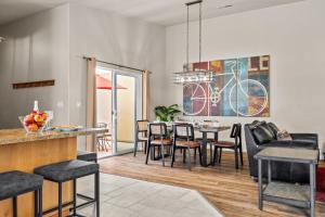 a dining room and living room with a table and chairs at Cottonwoods 347 in Moab