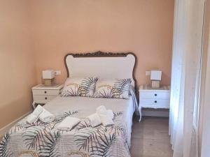 a bedroom with a large bed with two night stands at Casa Elisa 1 in León
