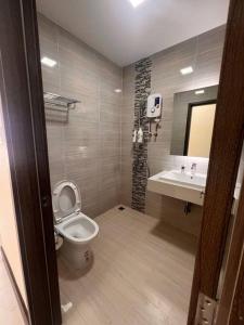 a bathroom with a toilet and a sink at Ideal Budget and Cozy Private Studio with Amazing Pool by SYM C738 in Phnom Penh