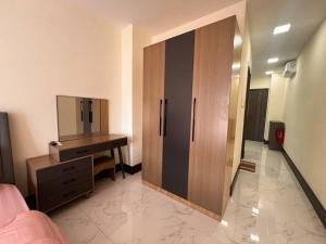 a bedroom with a dresser and a cabinet with a mirror at Ideal Budget and Cozy Private Studio with Amazing Pool by SYM C738 in Phnom Penh